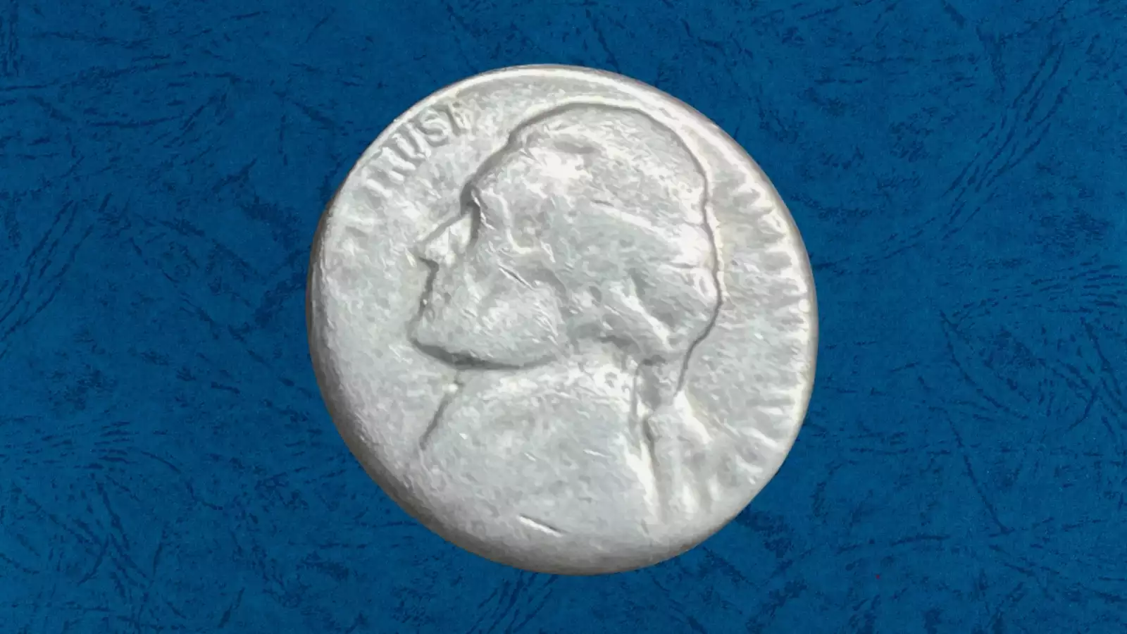 1955 Jefferson nickel off-center strike error showing crescent of blank planchet with date still visible